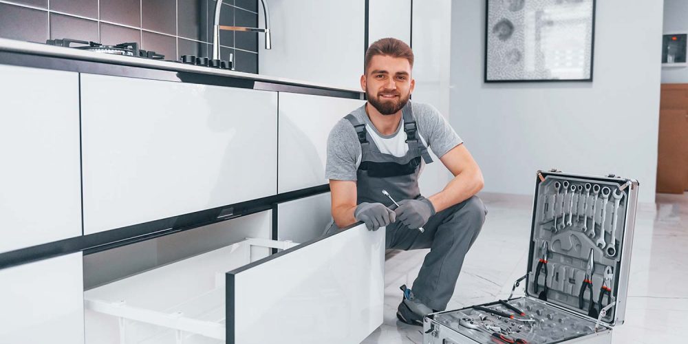 young-professional-plumber-in-grey-uniform-using-e-resize.jpg